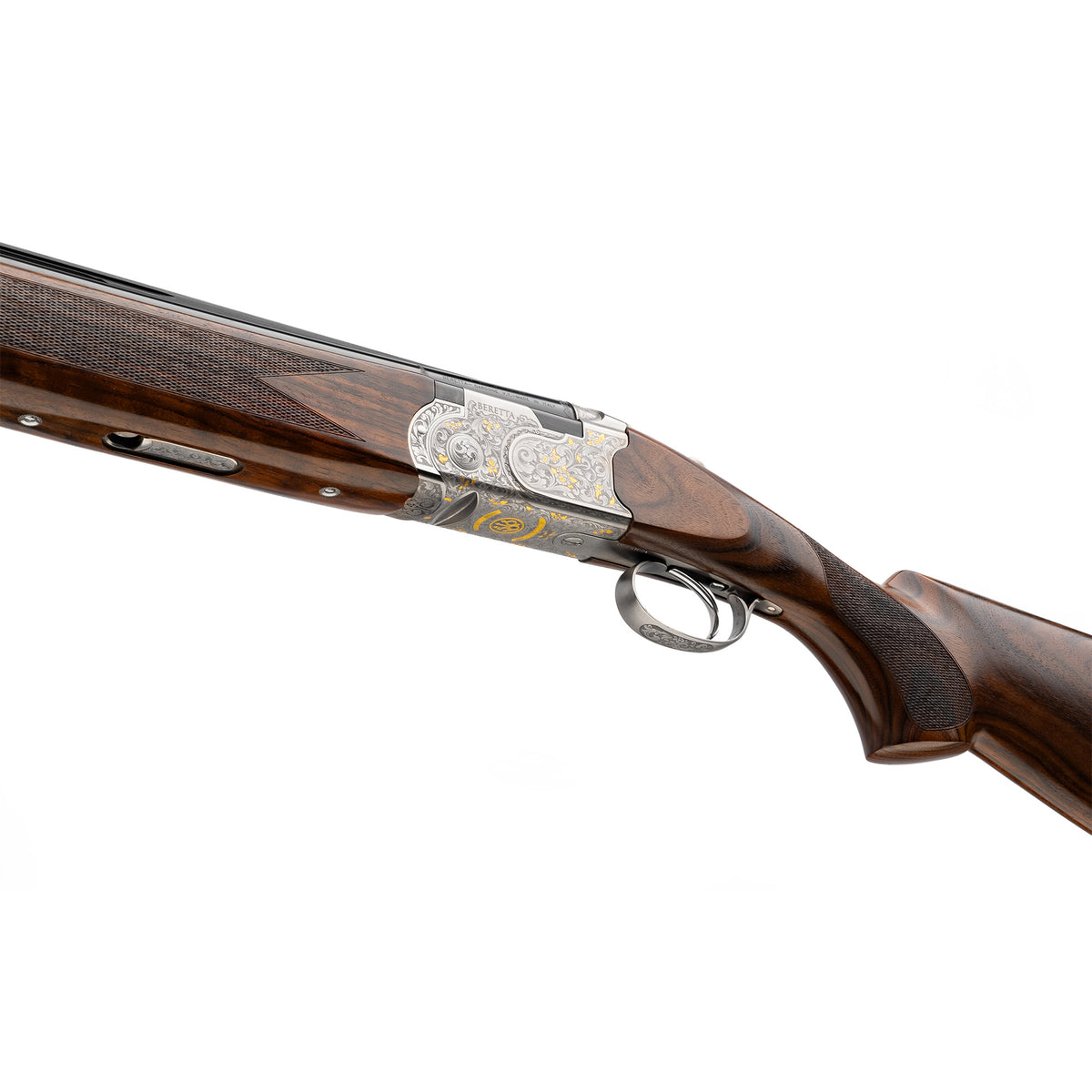 Close-up of a double-barrel shotgun showing the wooden stock, engraved silver metal receiver, and trigger guard against a white background.