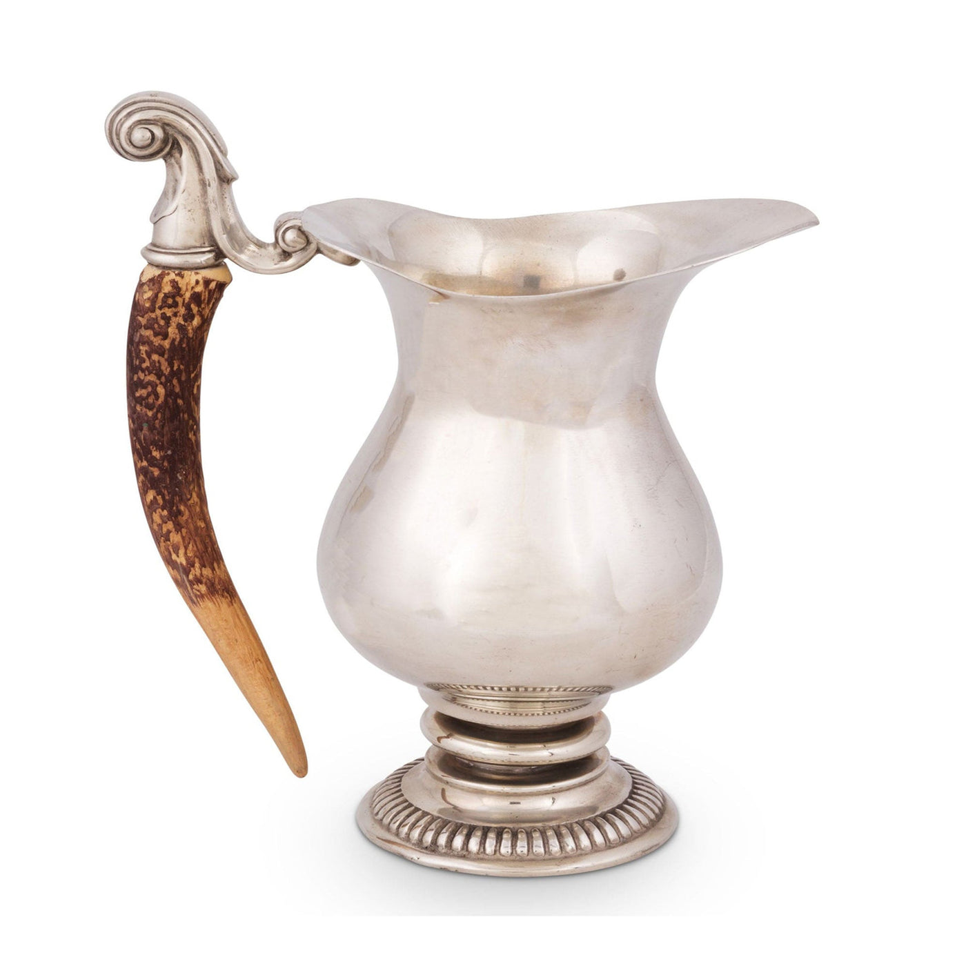 Silver pitcher with a decorative handle on a white background