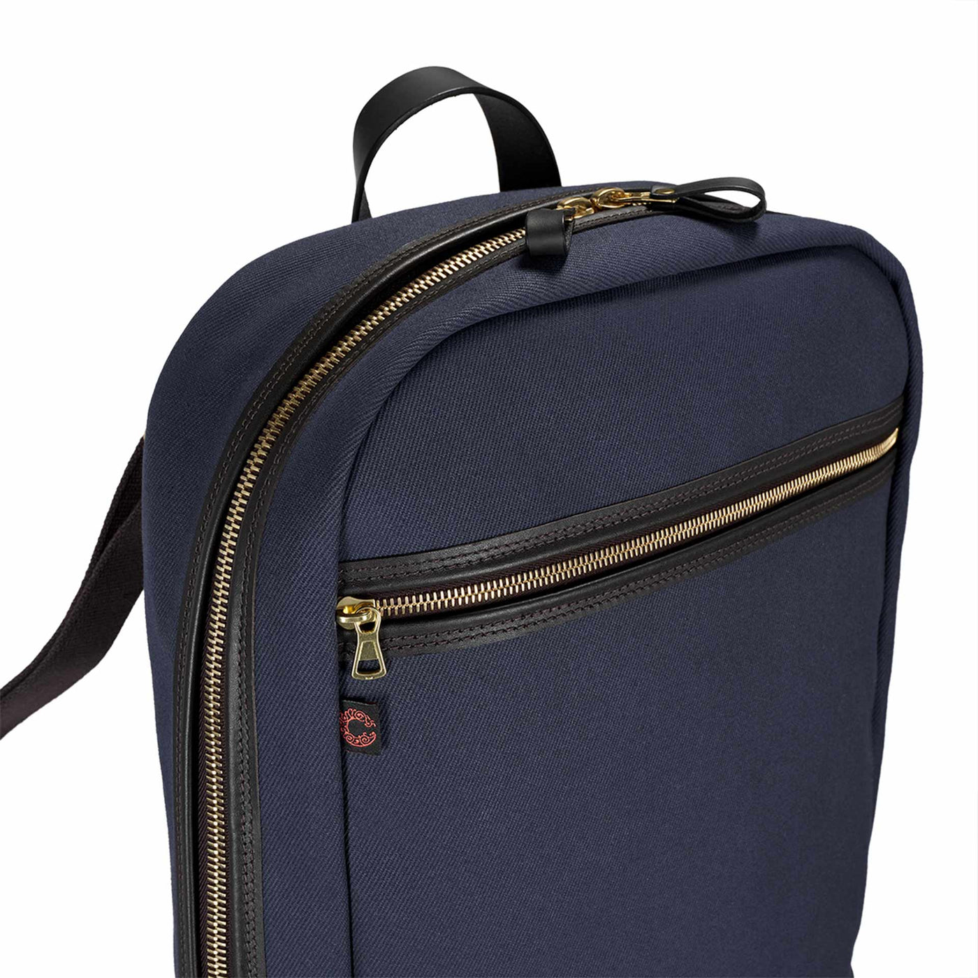 Navy blue backpack with gold zippers on a white background