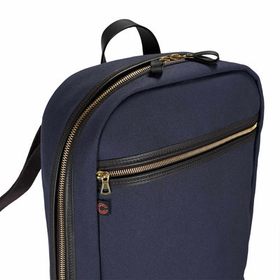 Navy blue backpack with gold zippers on a white background