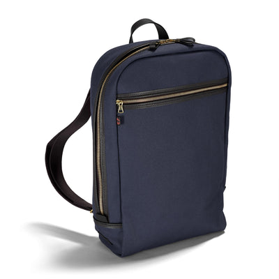 Navy blue backpack with gold zippers on a white background