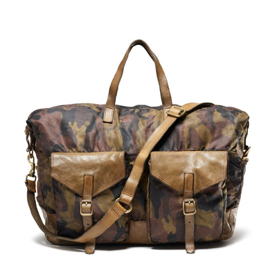 A camouflage weekender duffle bag with cowhide leather details, featuring a pair of handles and a shoulder strap.