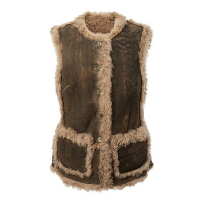 A brown reversible long shearling grizzly vest for women, with visible buttons and pockets on the front.