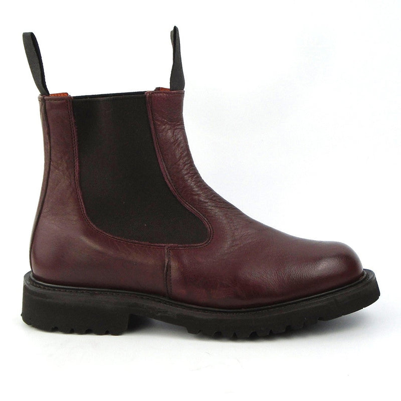 A burgundy women's Chelsea boot with a side elastic band and a storm welt on the sole.