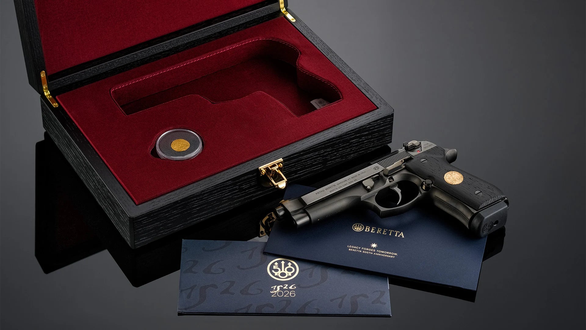 The Ducato collector's world: red-lined presentation case, historic Venetian ducat, anniversary documents, and the limited-edition pistol.