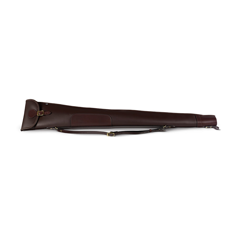 A dark havana brown leather shotgun slip with a flap and zip opening, featuring a traditional buckle and hand-sewn muzzle end.